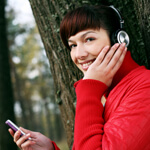 girl in stereo headphones and  mobile phone